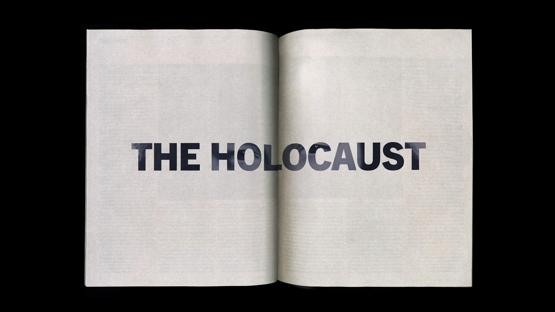 Open book with the words 'THE HOLOCAUST' printed across the two pages in bold letters.