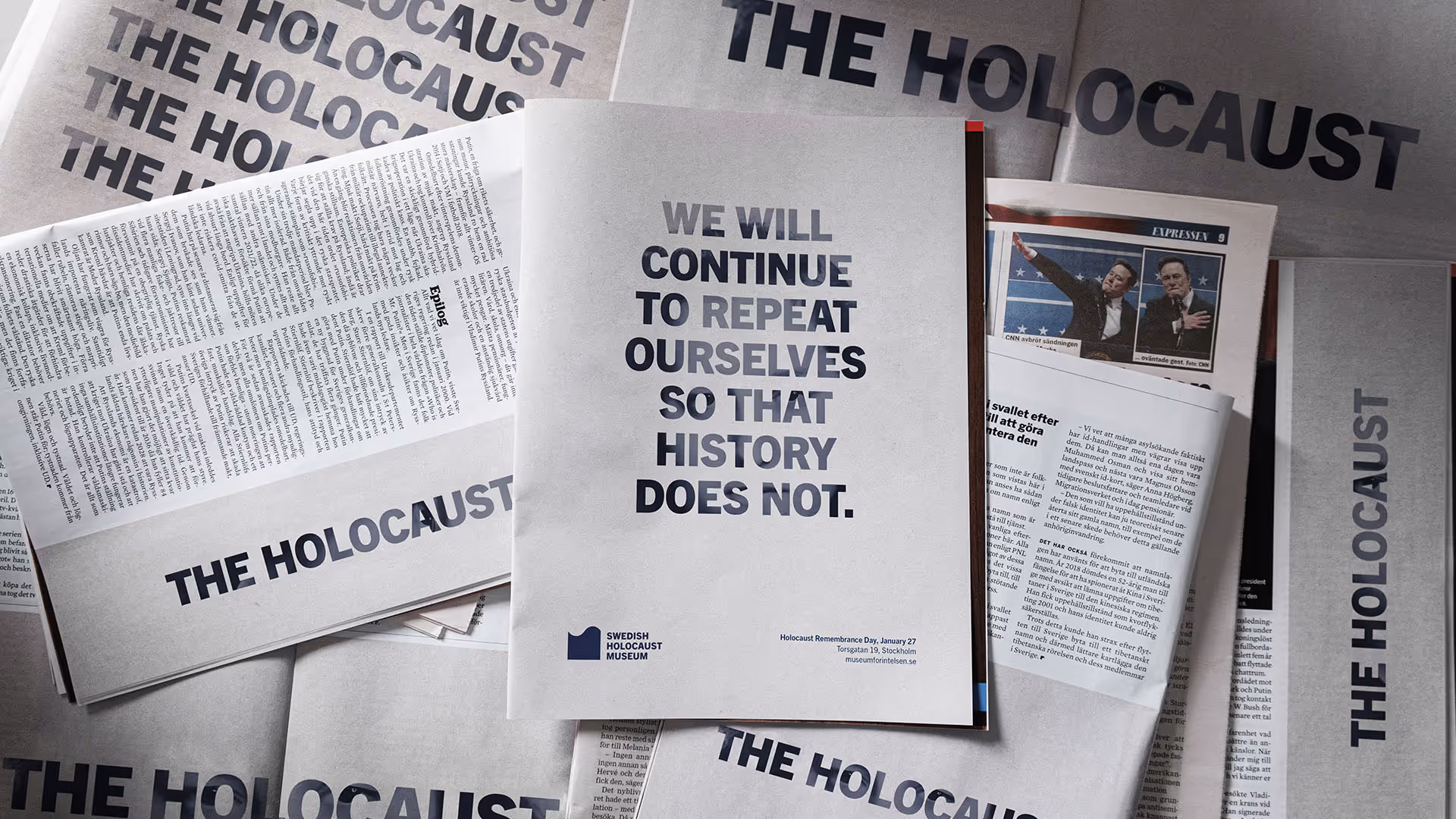 Flyers and newspapers with bold text about the Holocaust, featuring a central flyer saying 'We will continue to repeat ourselves so that history does not.'