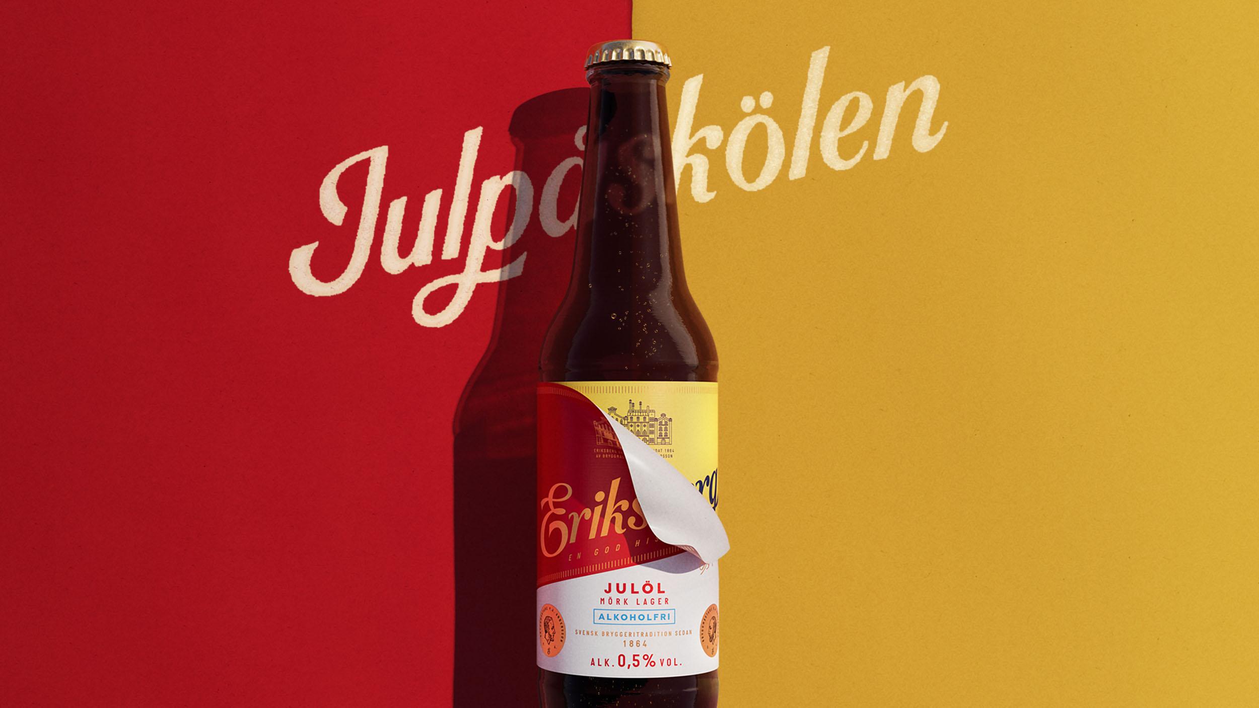 Bottle of Eriksberg Julöl alkoholfri dark lager beer with a red and yellow background and the word Julpaskolen in white script.